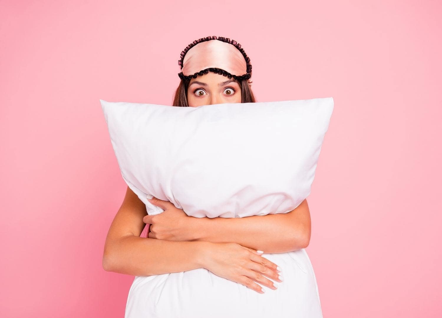 אישה מחבקת כרית, מאמר בלוג על שינה והקשר שלה לצוואר תפוס, כאבי ראש ממתח ומיגרנות